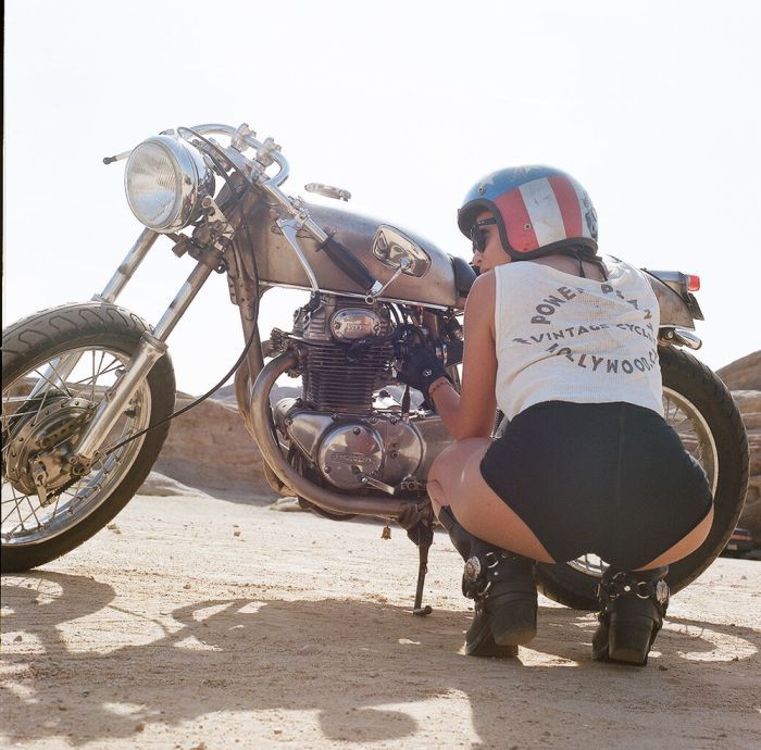 A playful frame from Girls on a motorcycle — online in Milan